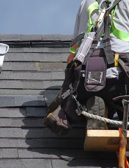 Man fixing roof tiles